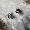 Two penguins are seen on a concrete surface near a person's feet, which are partially visible at the bottom of the image, suggesting an observational or interactive exhibit.