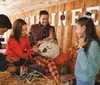 Two children are selecting pumpkins from a pumpkin patch at a farm