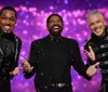 Three cheerful men in embellished black outfits are posing with expressive hand gestures against a vibrant purple bokeh background