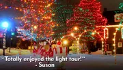 A festive outdoor scene at night featuring trees adorned with colorful Christmas lights and a Santa Claus figure in the foreground, enhanced by a snow-covered ground and a testimonial text overlay attributing enjoyment of the light tour to Susan.