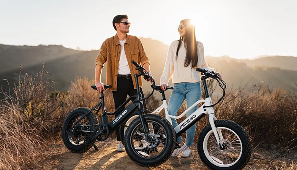 A man and a woman are standing with electric bicycles outdoors enjoying a sunny day