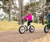 A man and a woman are standing with electric bicycles outdoors enjoying a sunny day