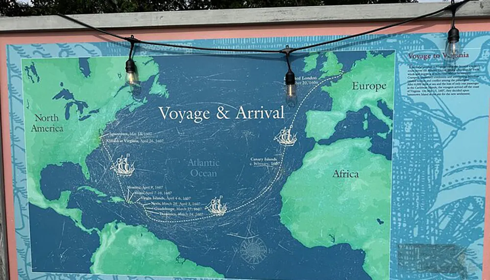 The photo shows an educational map display titled Voyage  Arrival detailing the transatlantic journey of ships from Europe to North America with strings of light bulbs hanging above it