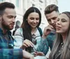 Four friends are sharing a meal and enjoying each others company on a city street