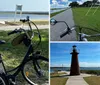 A bicycle with a basket and rear cargo rack is parked on the grass by a coastal roadway with a view of the water and clear sky in the background