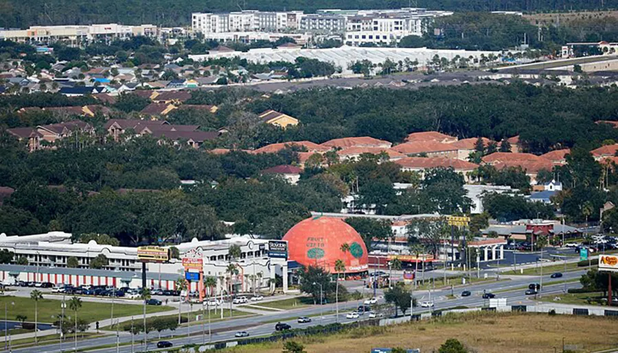 The image is an aerial view of a suburban area with a large, orange, dome-shaped building prominently labeled Florida Citrus Center amid roads, smaller commercial buildings, and residential neighborhoods.