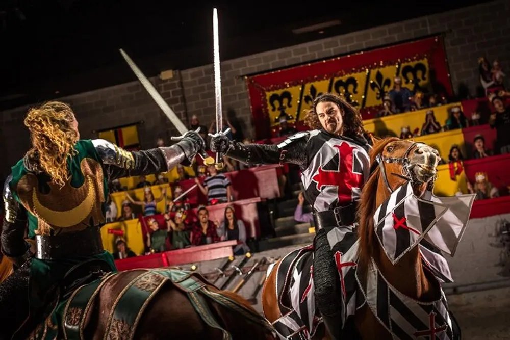 Two knights on horseback are engaged in a staged sword fight at a medieval-themed tournament as spectators watch from the stands