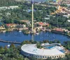 Two people are piloting a helicopter over a scenic coastal area with a clear view of the landscape and waterways below