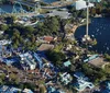 Two people are piloting a helicopter over a scenic coastal area with a clear view of the landscape and waterways below