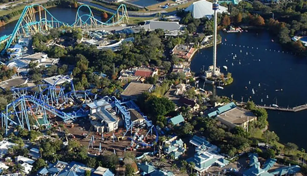 An aerial view of a theme park with roller coasters and a central lake