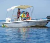 Three people wearing life jackets are enjoying a sunny day on a small motorboat with a Bimini top on a calm water body