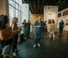 A woman is observing framed photographs displayed in an art gallery with wooden walls