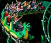 This image features costumed characters resembling LEGO figures in front of the LEGOLAND Florida entrance with colorful LEGO sculptures and the parks sign in the background