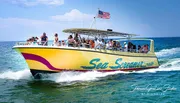 A group of people enjoys a sunny day on a speeding yellow boat named 