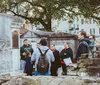 A group of people appear to be engaged in a guided tour in a historical cemetery