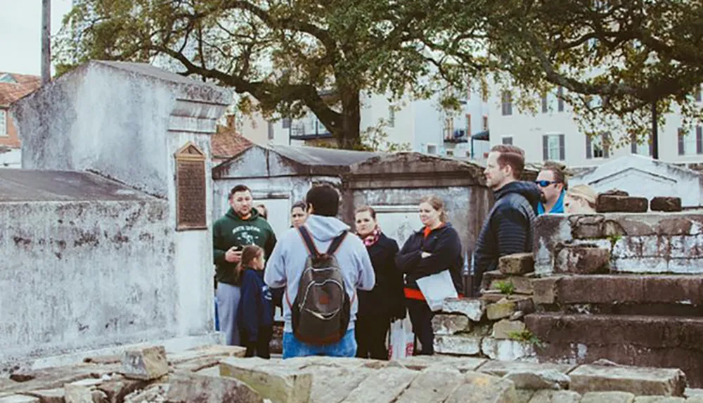 A group of people appear to be engaged in a guided tour in a historical cemetery