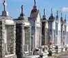 The image shows a row of above-ground tombs and mausoleums with varying designs characteristic of a historic cemetery