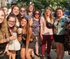 A group of people smiling and posing together for a photo on a sunny day