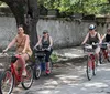A group of people is enjoying a bicycle ride together on a sunny day