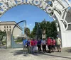 A group of people is posing for a photo under a large archway spelling out ARMSTRONG
