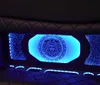 The image shows a cars luxury interior featuring blue ambient lighting and a Versace logo illuminated on the partition