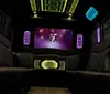 The image shows a cars luxury interior featuring blue ambient lighting and a Versace logo illuminated on the partition