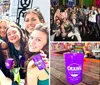 A group of people are enjoying themselves on a balcony with drinks beads and smiles possibly during a festive event