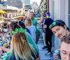 A group of people are enjoying themselves on a balcony with drinks beads and smiles possibly during a festive event