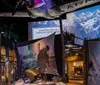 A group of people explore a museum exhibit featuring historical photographs and interactive displays in a dimly lit arched room