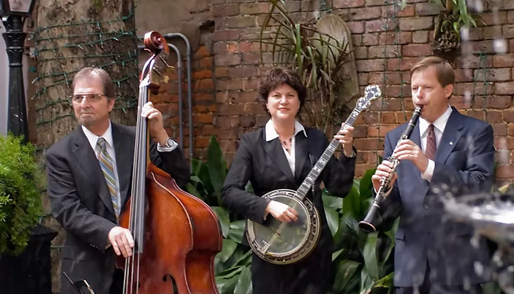 Three musicians in formal attire play string bass banjo and clarinet in an outdoor setting