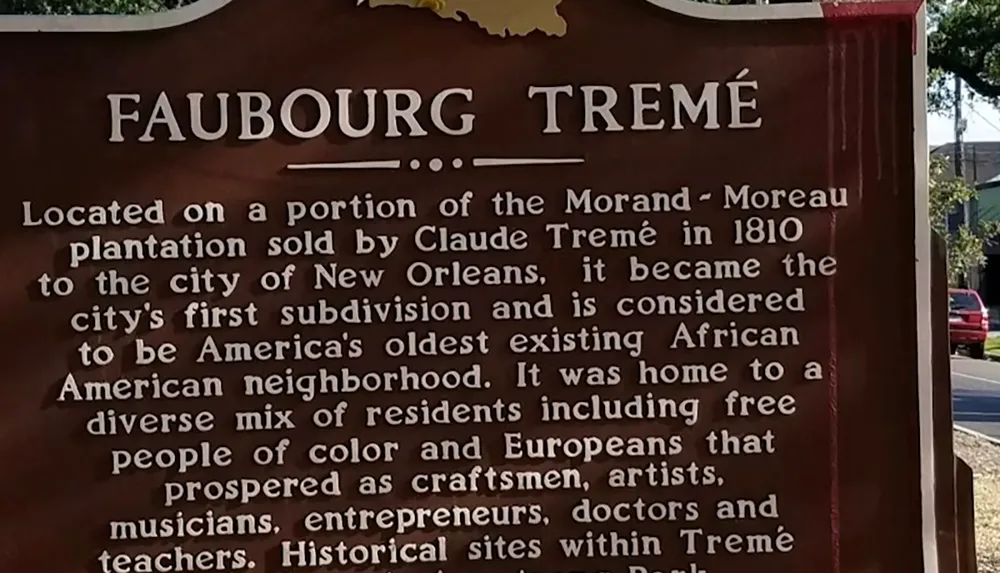 The image shows a historical marker for Faubourg Trem highlighting its significance as Americas oldest existing African American neighborhood established from land sold in 1810 and known for its diverse and prosperous community