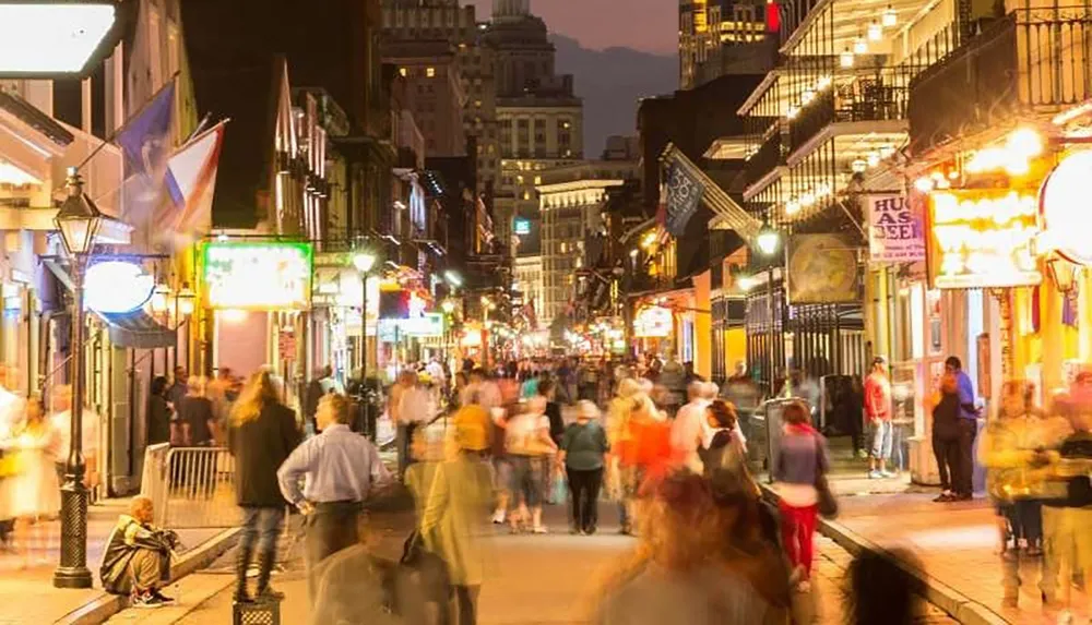 The image depicts a lively and crowded street at night filled with people and colorful illuminated signs