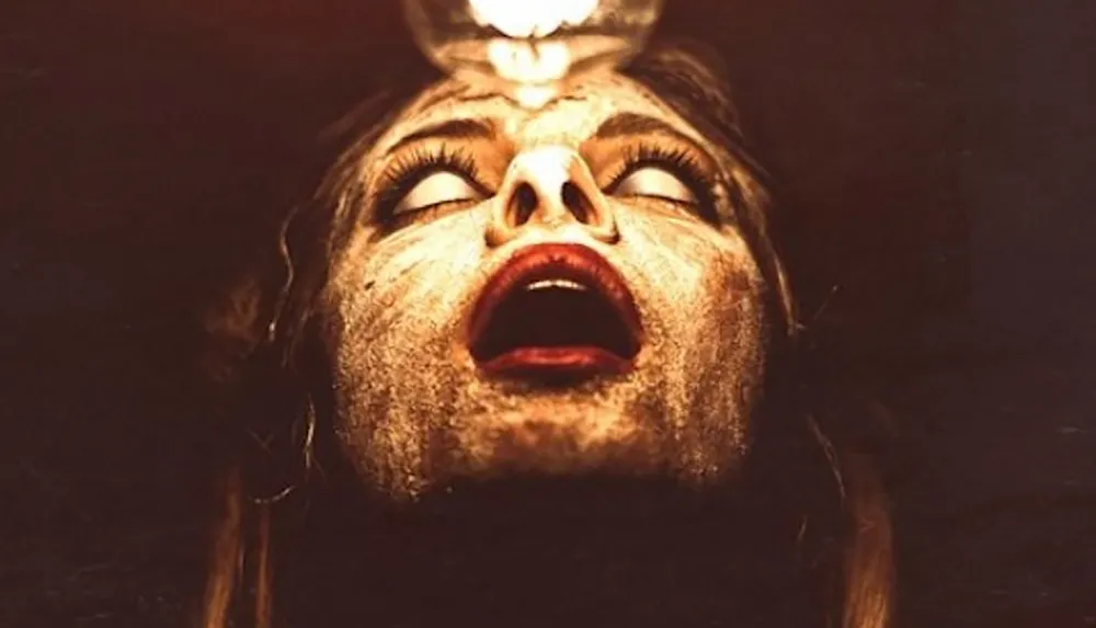 The image depicts a person with a dirtied face and upward gaze illuminated by a single light source above them creating an eerie and dramatic effect