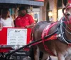 A group of people are enjoying a horse-drawn carriage ride on a lively city street at night