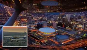 This image shows a vibrant, aerial view of a city at dusk, with illuminated buildings and streets, captured from the cockpit of an aircraft.