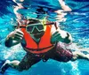 A person is giving a thumbs-up while snorkeling underwater