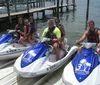 A person is riding a yellow and black jet ski on the water at high speed