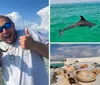 A man gives a thumbs-up while happily displaying a small fish in front of a boat anchored in shallow waters