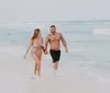 The image is a collage of five different beach-themed photos featuring various people engaging in activities such as hugging jumping joyfully and walking on a pier