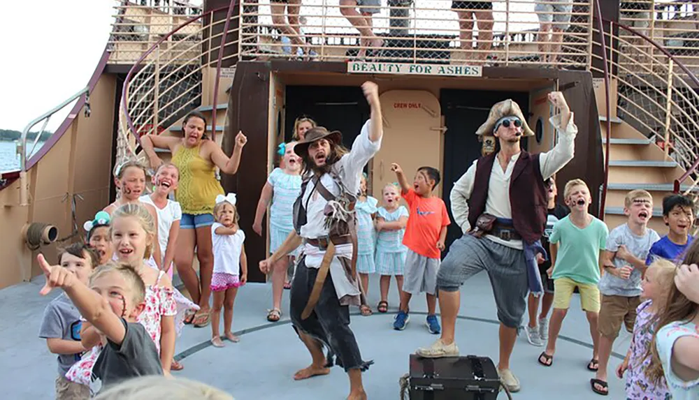 A group of excited children and adults are participating in an interactive pirate-themed activity aboard a boat