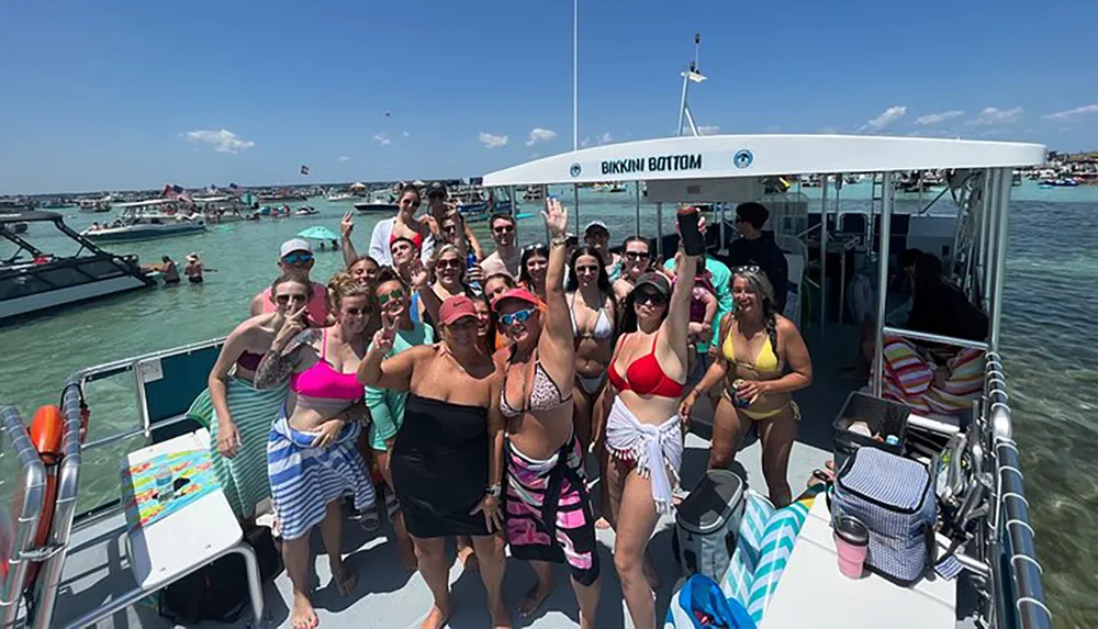 A group of people in swimwear are posing for a photo on a boat named Bikini Bottom surrounded by other boats and people enjoying the water