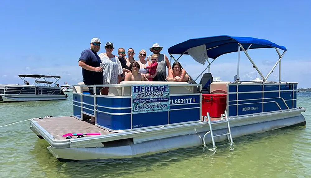 A group of people enjoys a sunny day on a pontoon boat on calm waters with other boats in the background