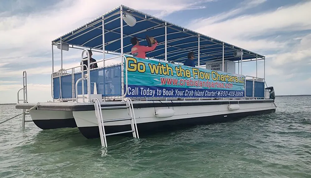 The image shows a pontoon boat with a large Go with the Flow Charters banner seemingly designed for recreational outings on the water