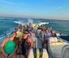 A group of happy people is enjoying a sunny boat ride on a clear blue water body