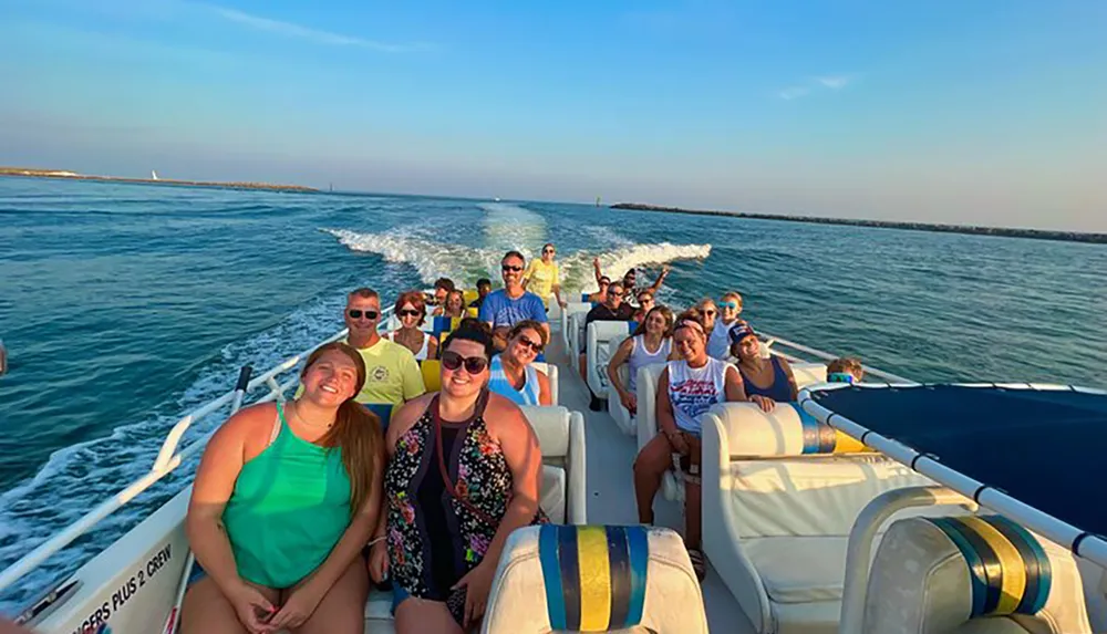 A group of happy people is enjoying a sunny boat ride on a clear blue water body