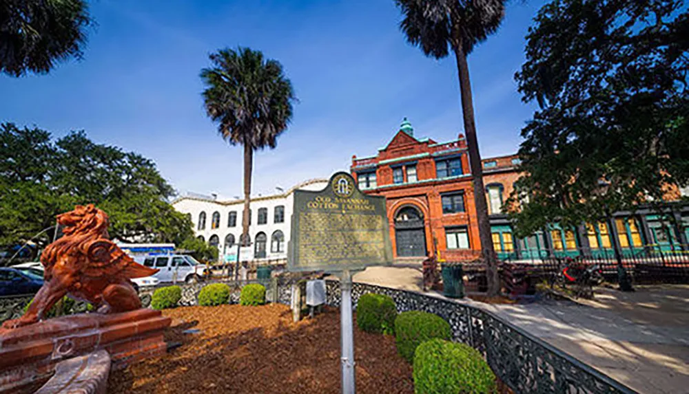 The image features the historic Old Savannah Cotton Exchange building in Savannah Georgia framed by palm trees with a foreground historical marker and lion sculpture