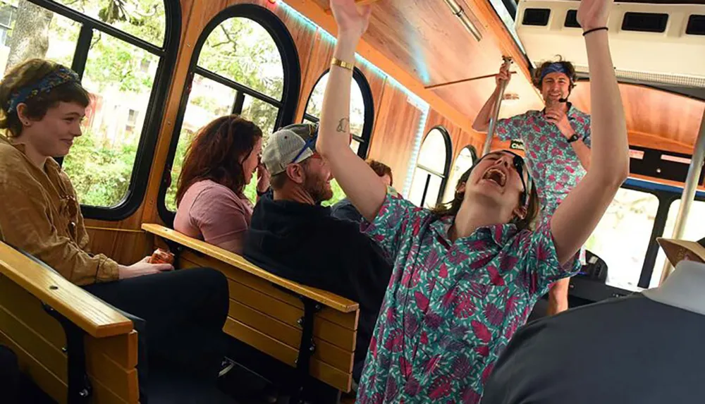 A group of joyful people one laughing ecstatically are riding in a trolley with wooden seats and large windows