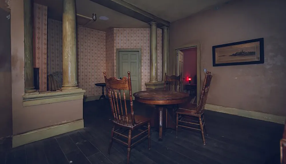 The image shows an old-fashioned room with wooden furniture floral wallpaper and a dim moody atmosphere