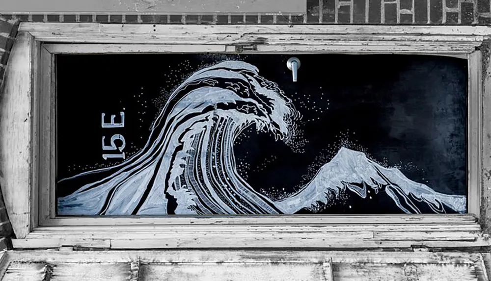 This is a street art depiction of a stylized wave and mountain reminiscent of the famous Great Wave off Kanagawa woodblock print by Hokusai painted on a window with an address number 15E above it