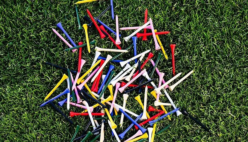 This is an image of multicolored golf tees scattered on a grass surface